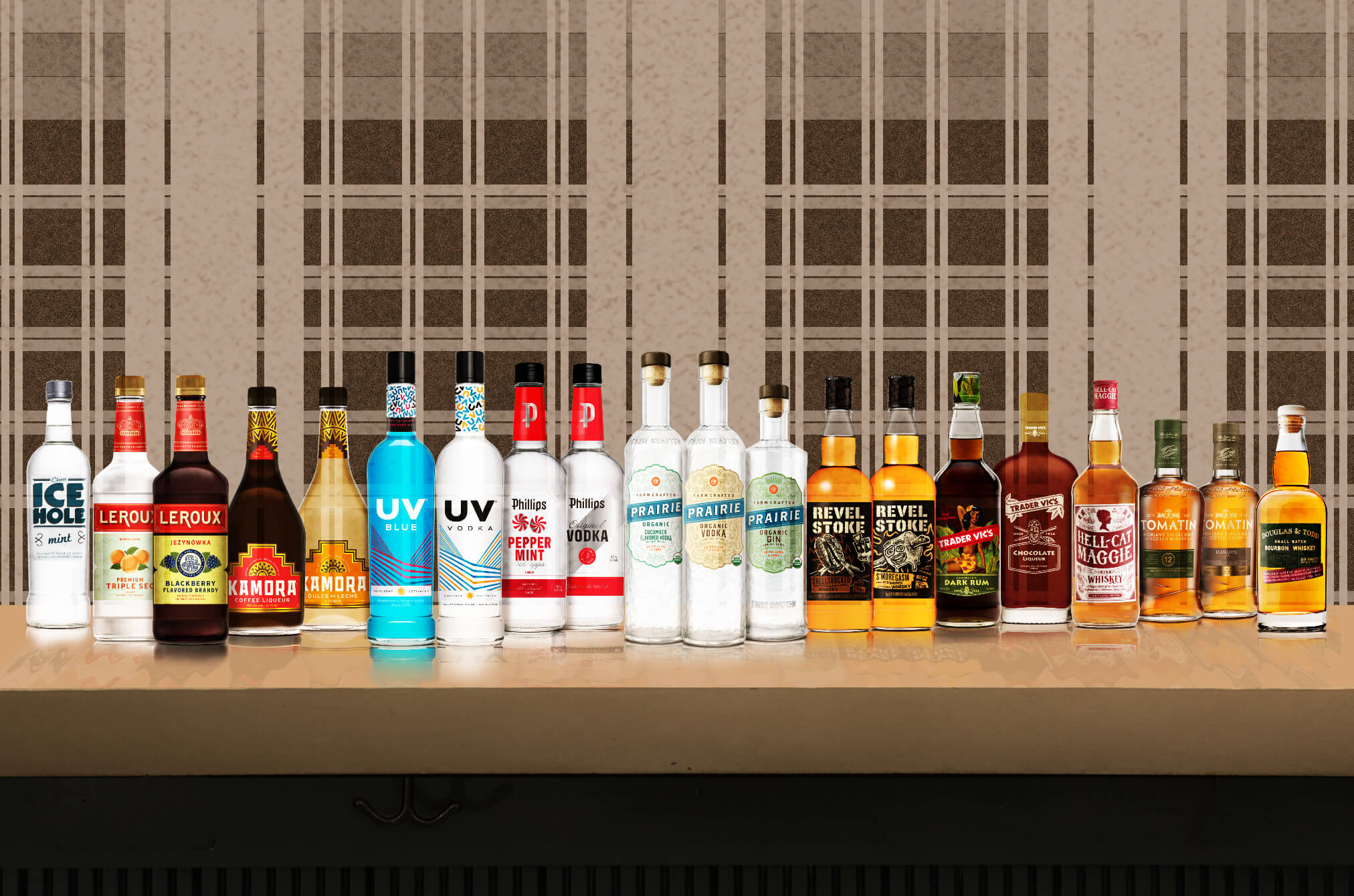 A line of alcohol bottles on a bar with a plaid background